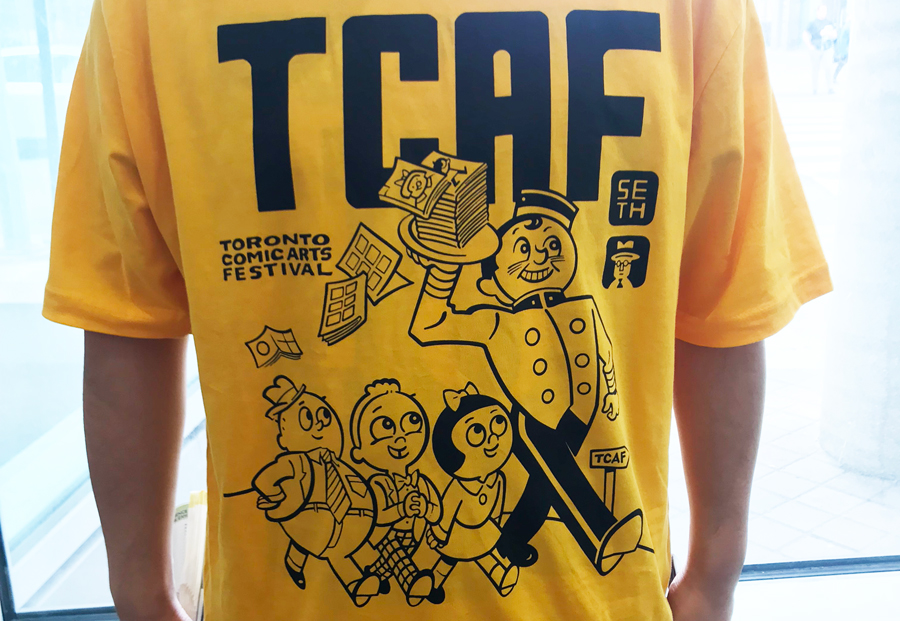 A photo of the TCAF shirt being worn by an event volunteer